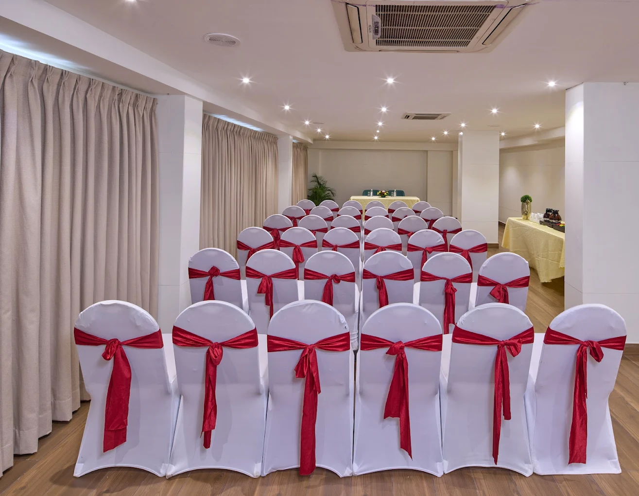 Outdoor dining setup with long table and floral arrangements