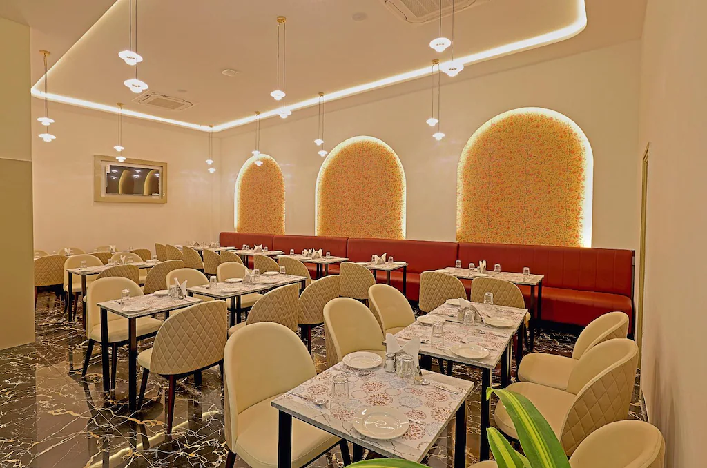 Elegant banquet hall with round tables and chandelier lighting